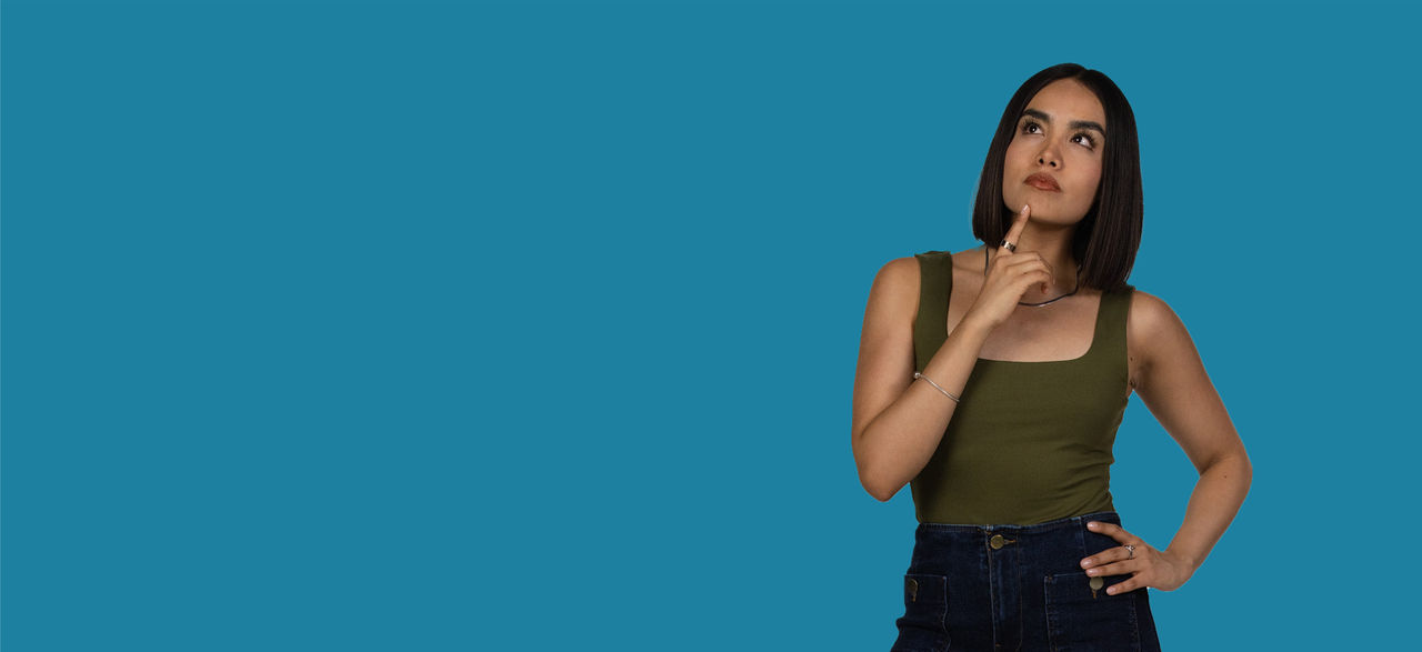 Person looking upward against a blue background